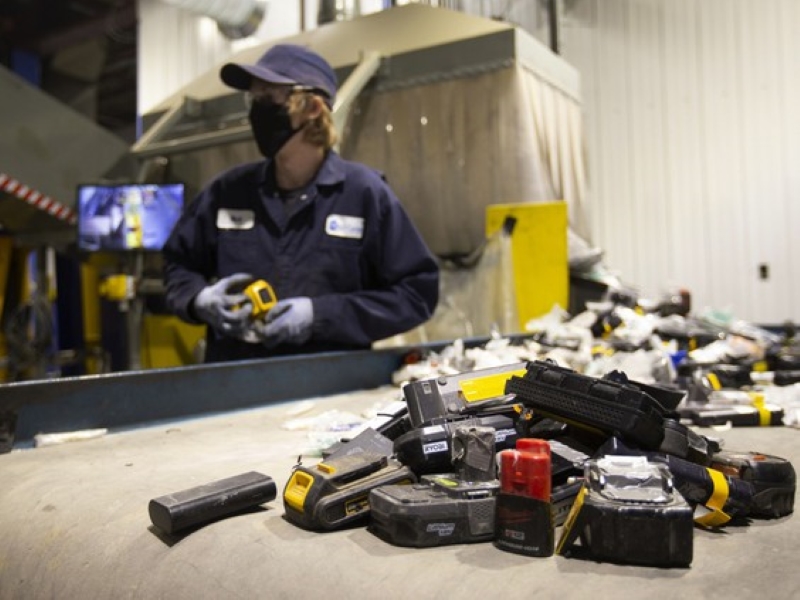 Li-Cycle team member sorting lithium-ion batteries to be shredded