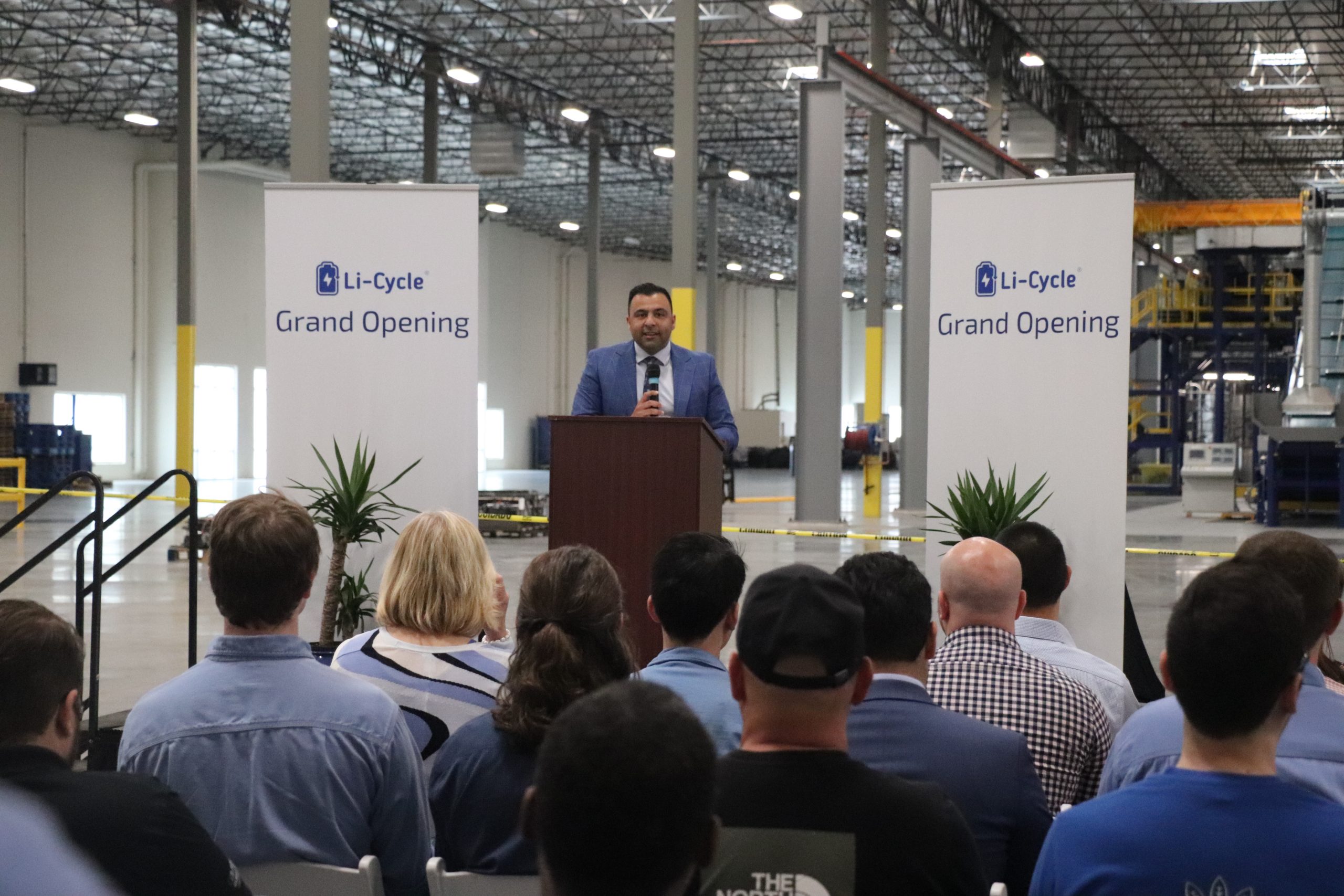 Ajay Kochhar, CEO and co-founder of Li-Cycle speaking at a podium at Arizona Spoke Grand Opening